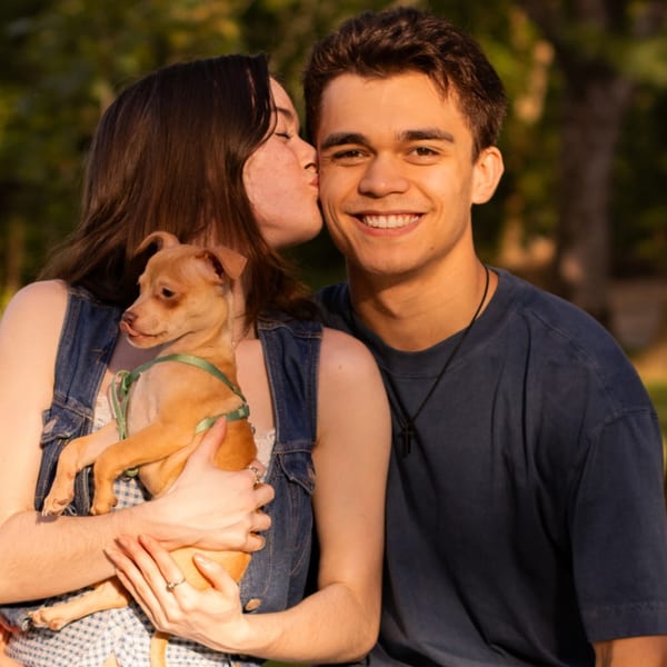 Isaah Jacob, founder of KineticConversion, outdoors with his partner and their dog
